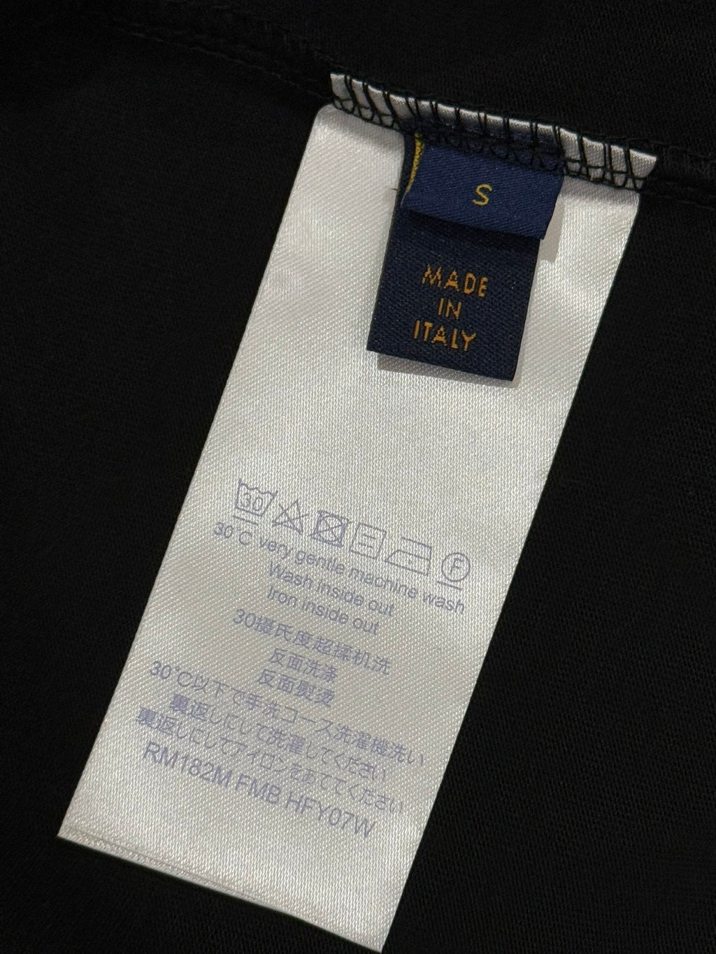Inside neck label shows size S and 'Made in Italy' on black T-shirt