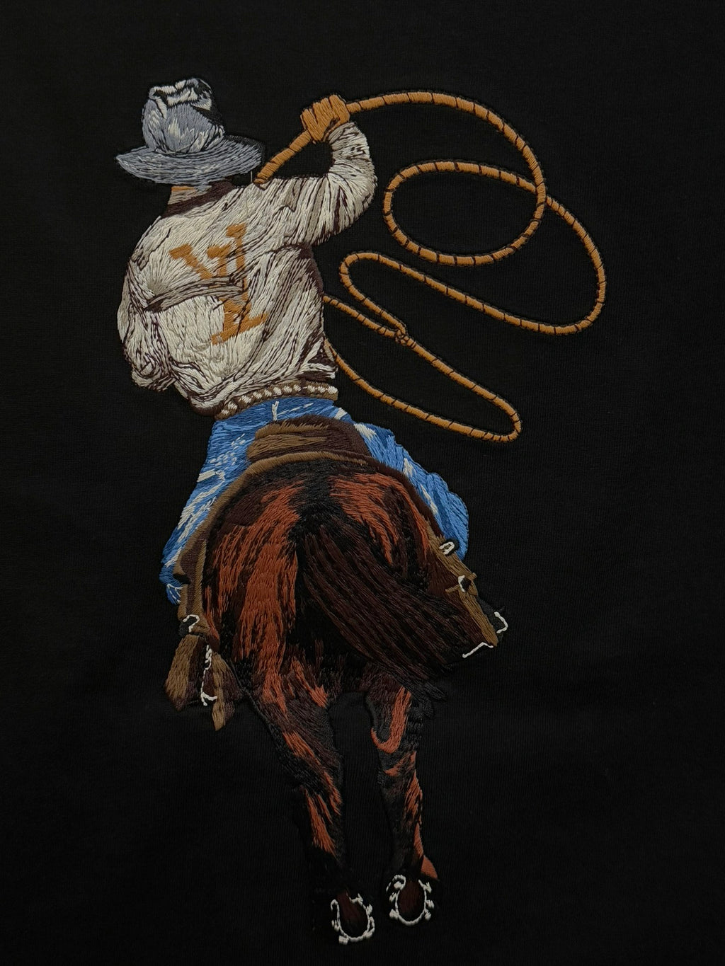 Black crewneck T-shirt with large embroidered rider graphic