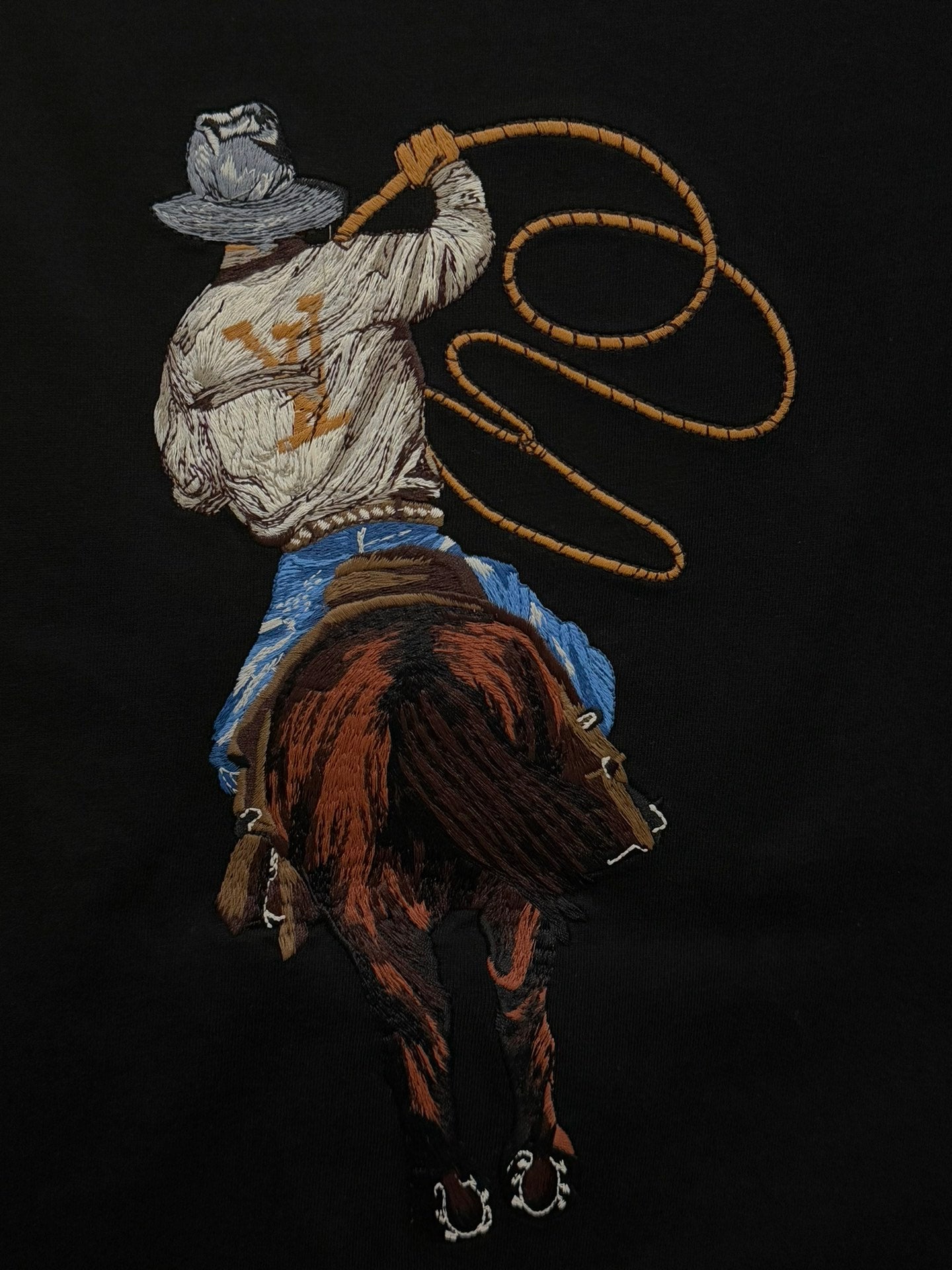 Black crewneck T-shirt with large embroidered rider graphic