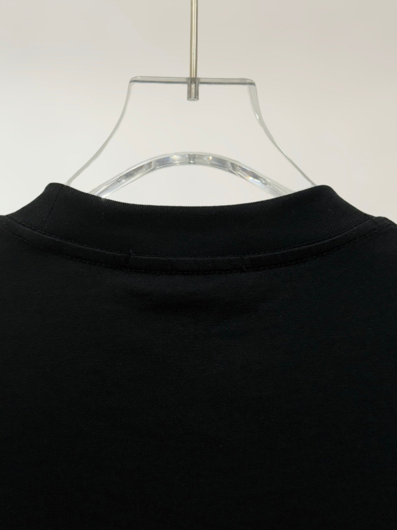 Black crewneck T-shirt neckline with ribbed collar