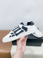 Low-top lace-up sneakers in white with navy panels and textured white sole