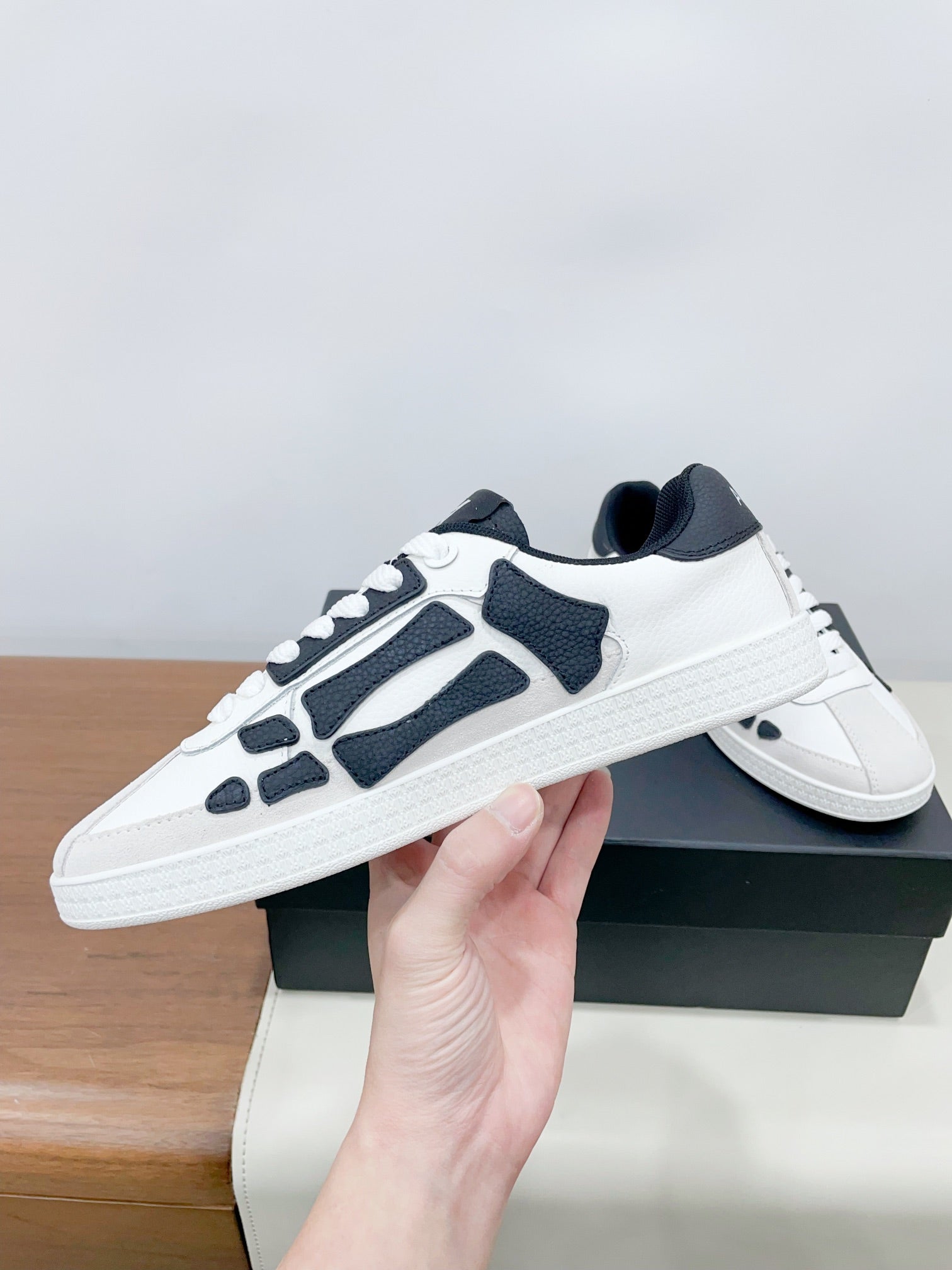 Low-top lace-up sneakers in white with navy panels and textured white sole