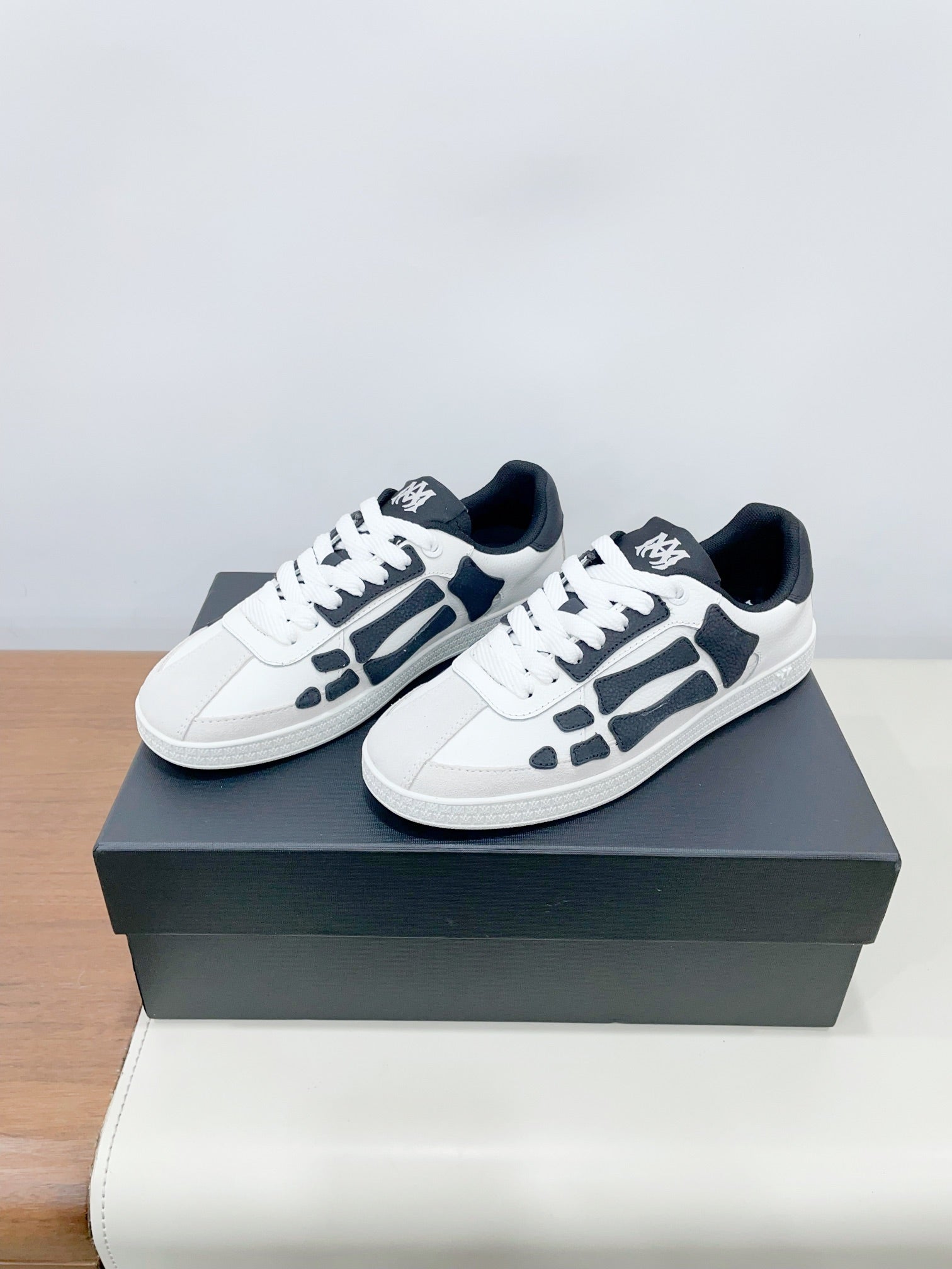 Low-top lace-up sneakers with white uppers and navy patterned panels