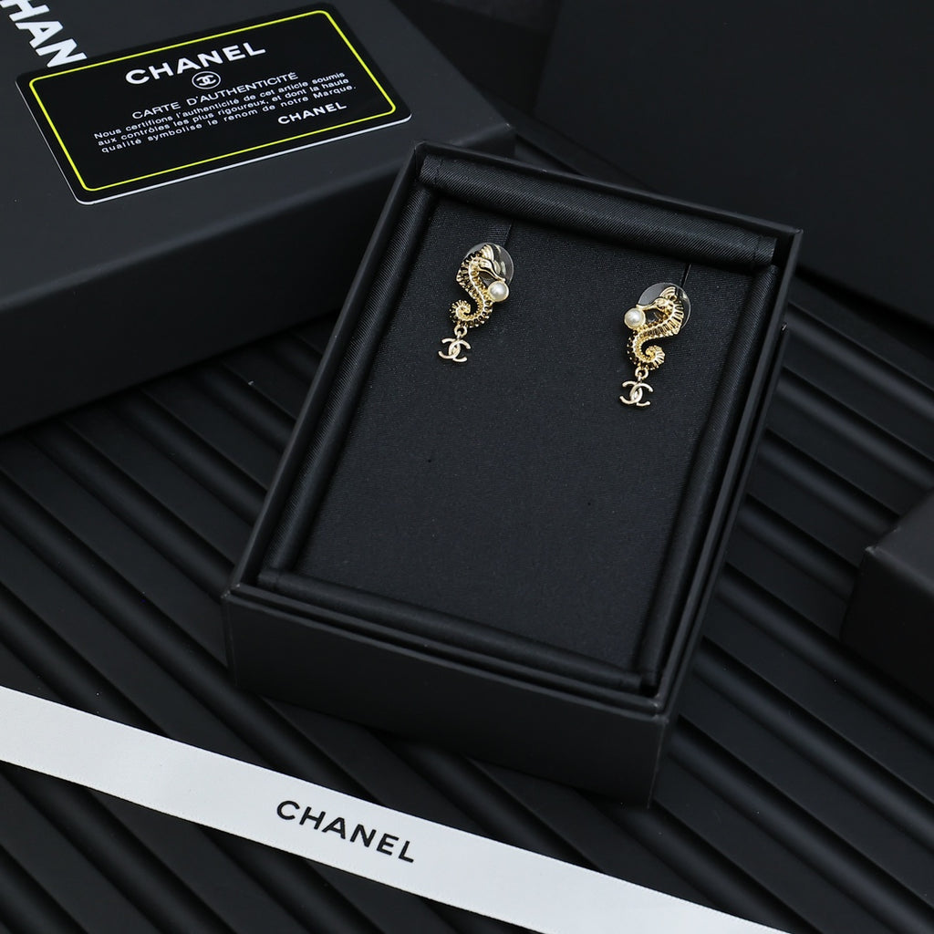 Gold-tone dangle earrings with pearls and Chanel CC logo charm, front view