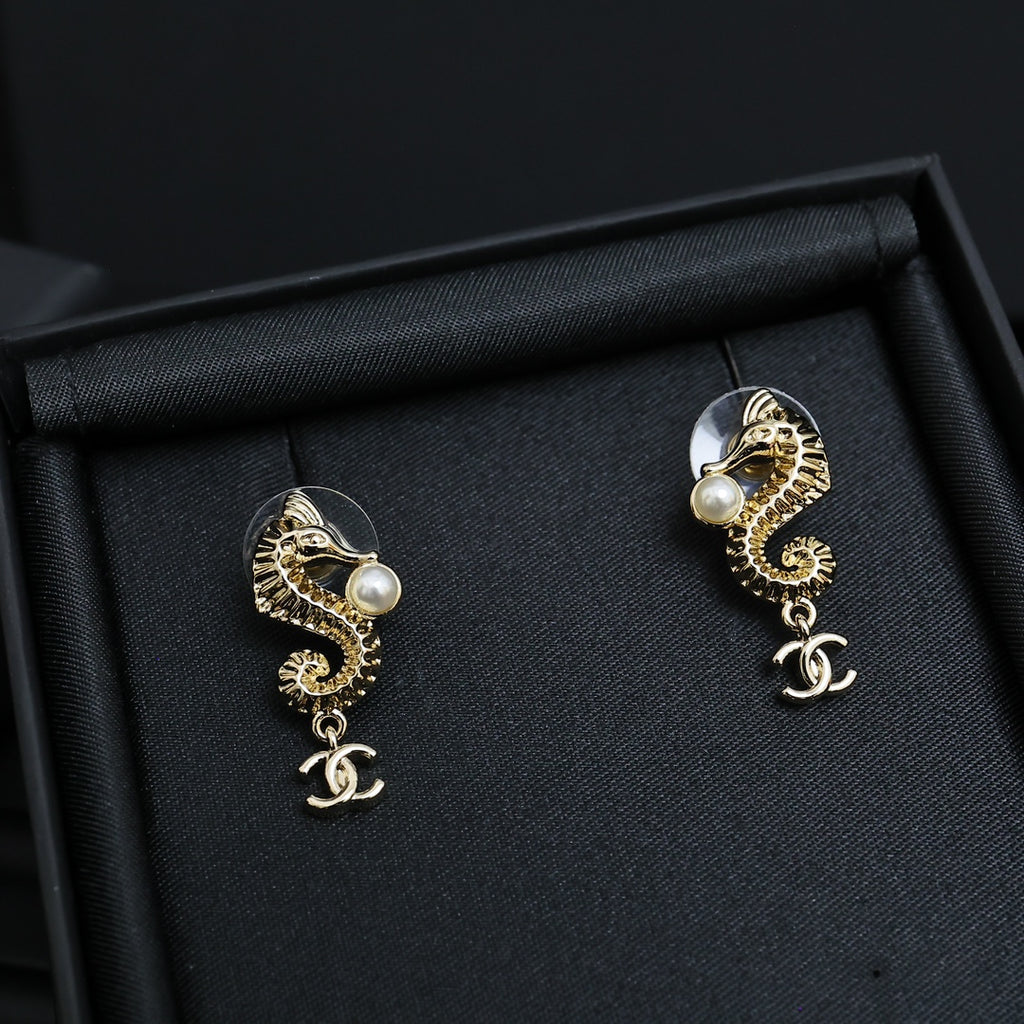 Gold-tone dangle earrings with pearl accents and Chanel CC charm drop, pair