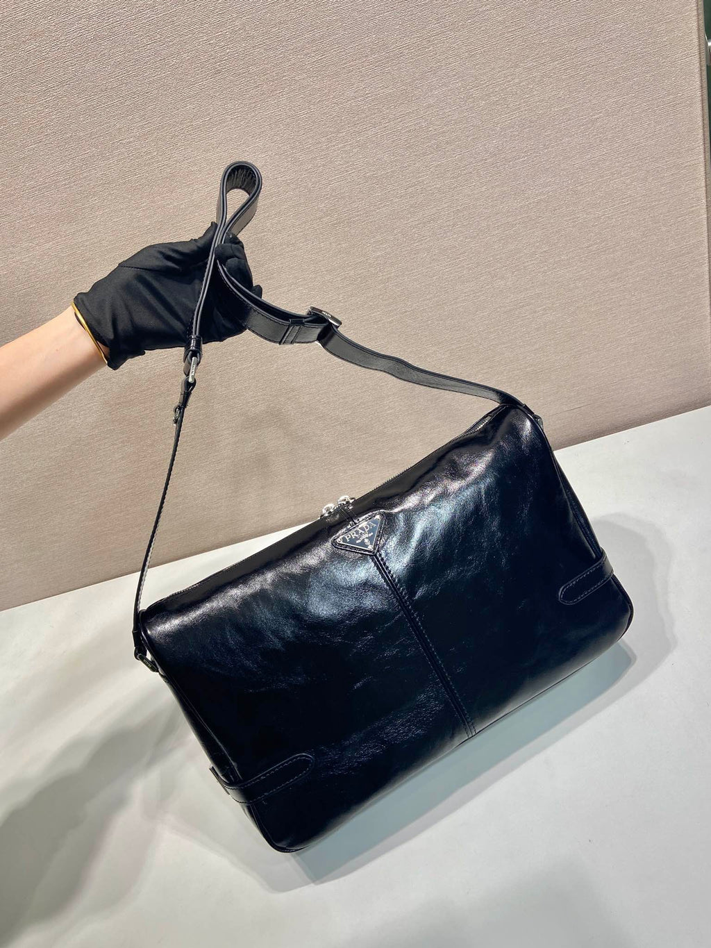 Dark navy leather hobo shoulder bag with adjustable crossbody strap