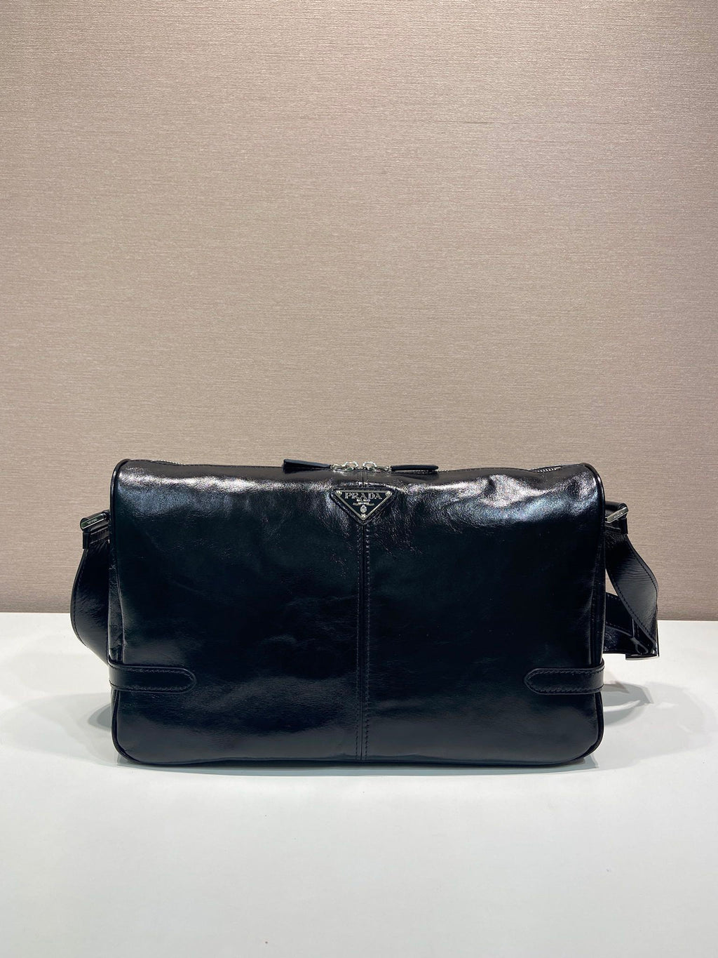 Dark navy leather shoulder bag with front flap and snap details
