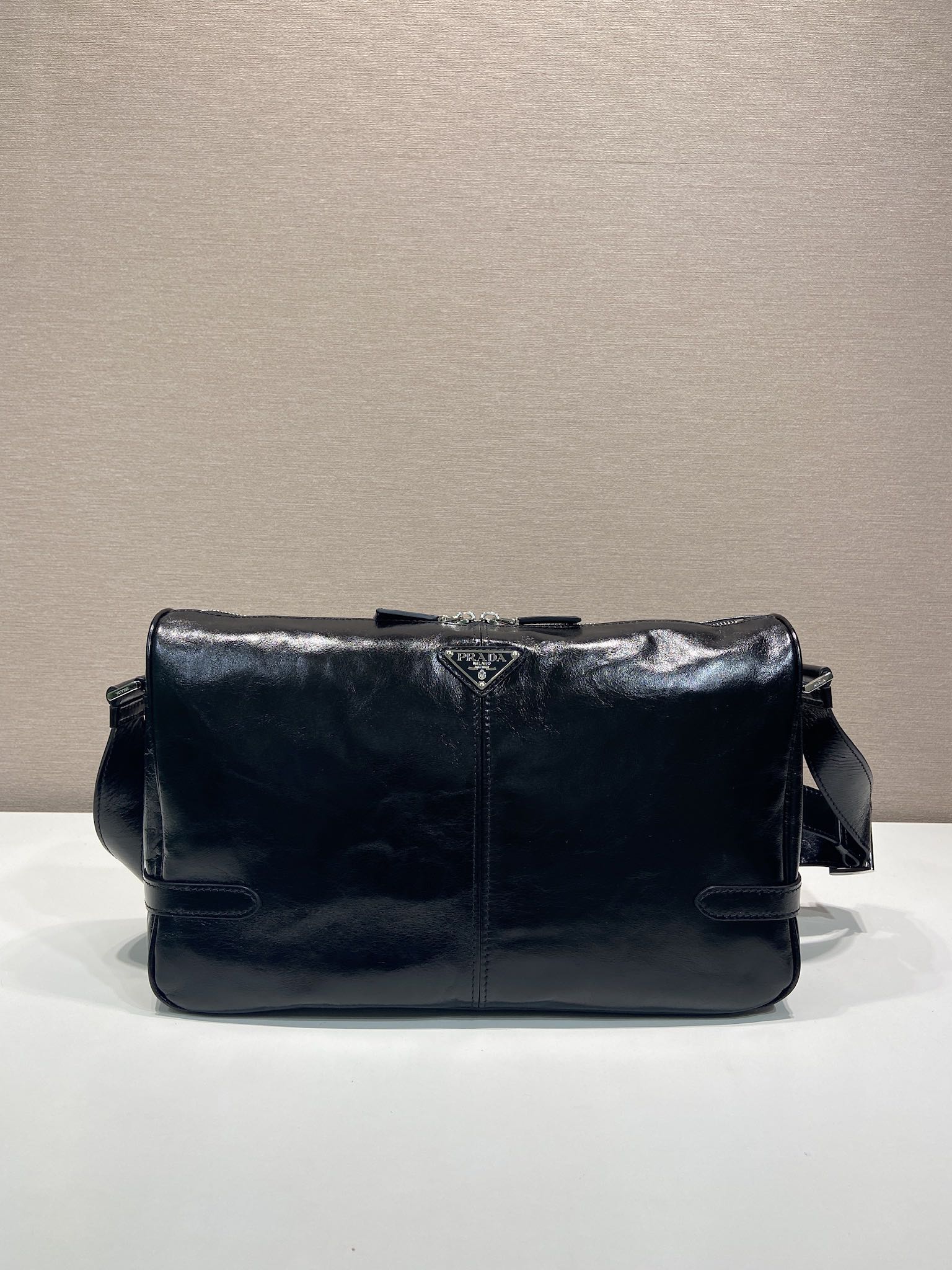 Dark navy leather shoulder bag with front flap and snap details
