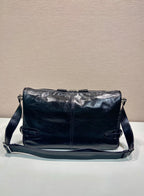 Dark navy leather crossbody bag with adjustable strap and front flap