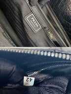 Dark navy leather bag interior with Prada label and zipper stitching detail