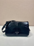 Prada shoulder bag in dark leather with front triangle logo and flap
