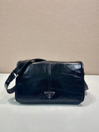 Prada shoulder bag in dark leather with front triangle logo and flap