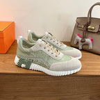 Low-top unisex sneakers with lace-up front, light green accents, grippy sole tread