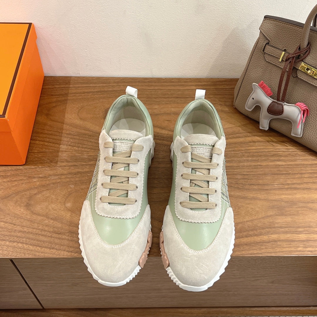 Low-top unisex sneakers with white and light green panels, lace-up design, rubber sole