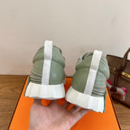 Unisex sneakers heel view with white and light green uppers and chunky rubber soles