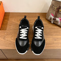Black Hermes unisex sneakers with white laces and chunky white rubber sole