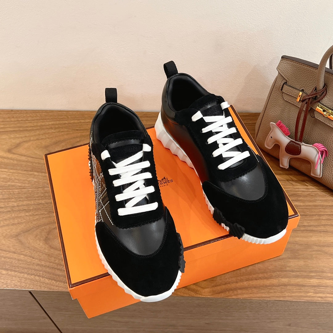 Black Hermes unisex sneakers with white laces and side black leather overlays