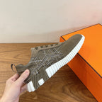 Hermes unisex sneaker close-up with olive suede upper and white ridged sole