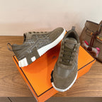 Hermes unisex sneakers showing side with olive suede panels and white rubber sole