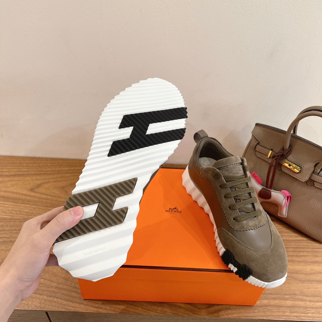 Hermes unisex sneaker outsole view with black traction pattern and white rubber sole
