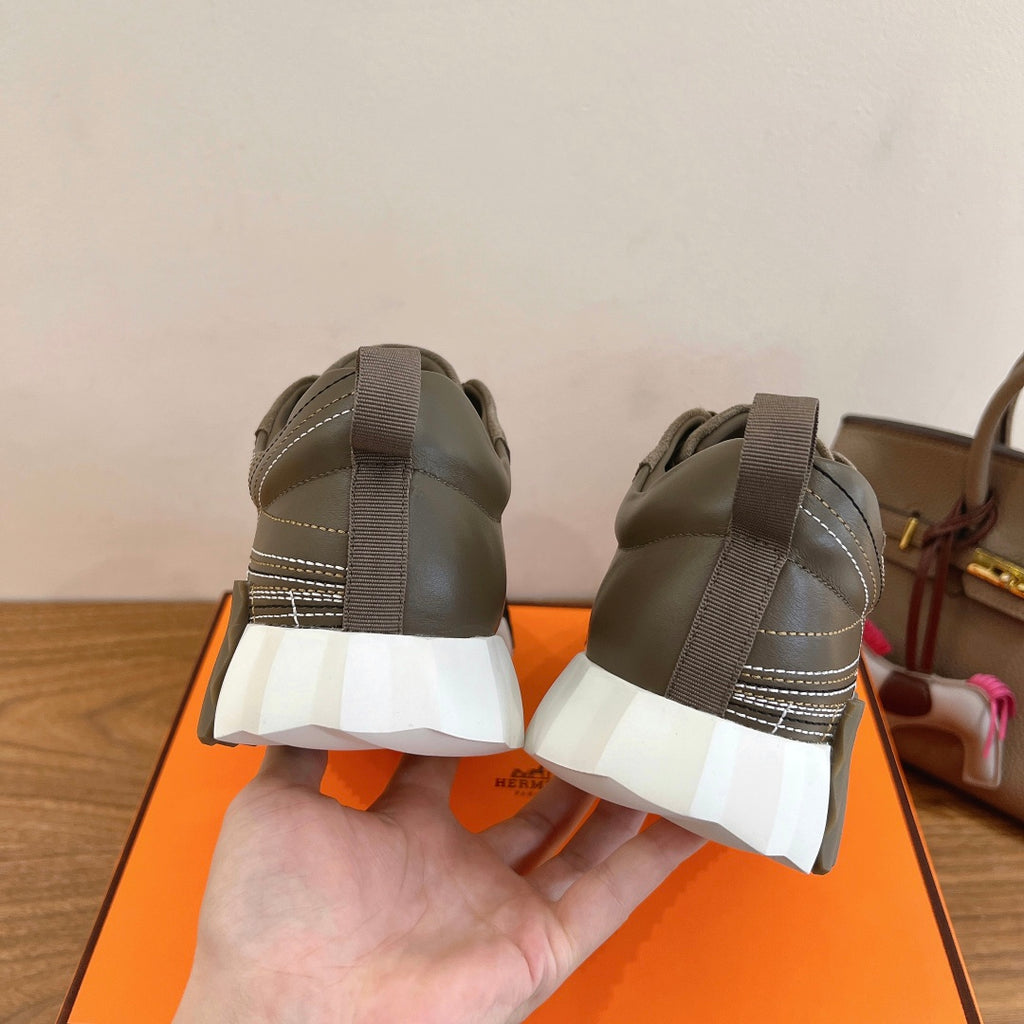 Hermes unisex sneakers heel view in olive suede with gray elastic pull tabs