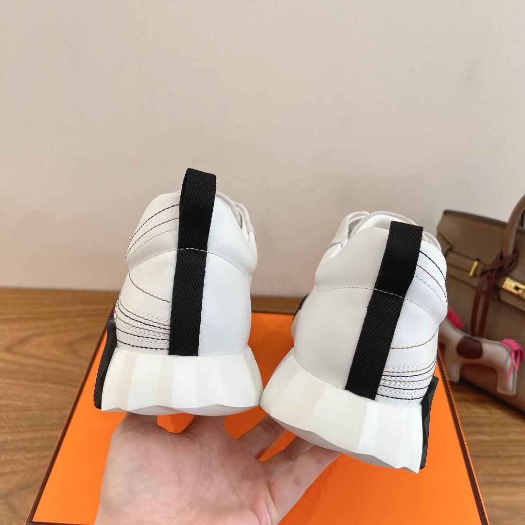 Hermes unisex sneakers, back view with black heel strap and cushioned sole