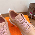 Hermes unisex sneaker in light pink with pink laces, suede tongue, and logo on side