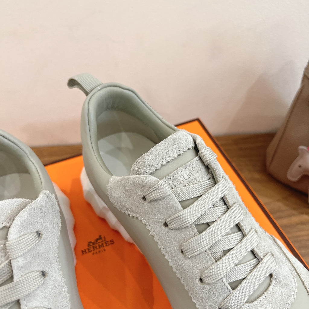 White sneakers with lace-up closure and textured suede collar lining, close-up.