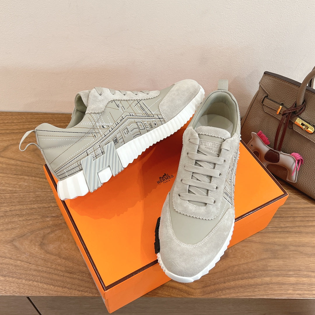 White lace-up sneakers with geometric logo overlay and padded tongue, unisex.