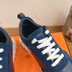 Unisex blue sneakers with white laces and visible HERMES logo on side