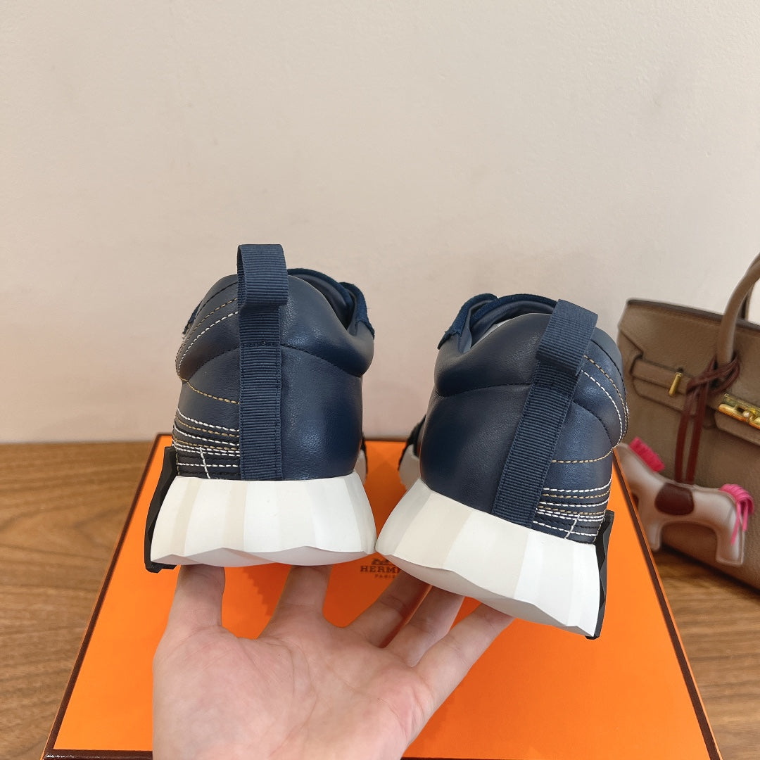 Unisex blue sneakers with white soles, rear view with heel pull tabs