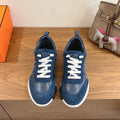 Unisex blue sneakers with white laces and white rubber sole, side panels visible