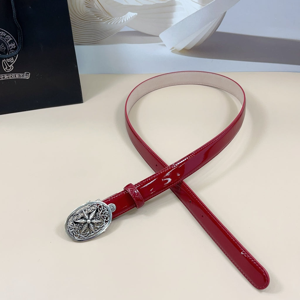 Red leather belt with silver filigree buckle, adjustable holes, and short tail