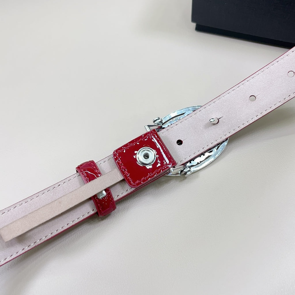 Red belt with silver buckle hardware and light strap lining, shown from side
