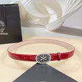 Red leather belt with silver round filigree buckle and metal eyelets