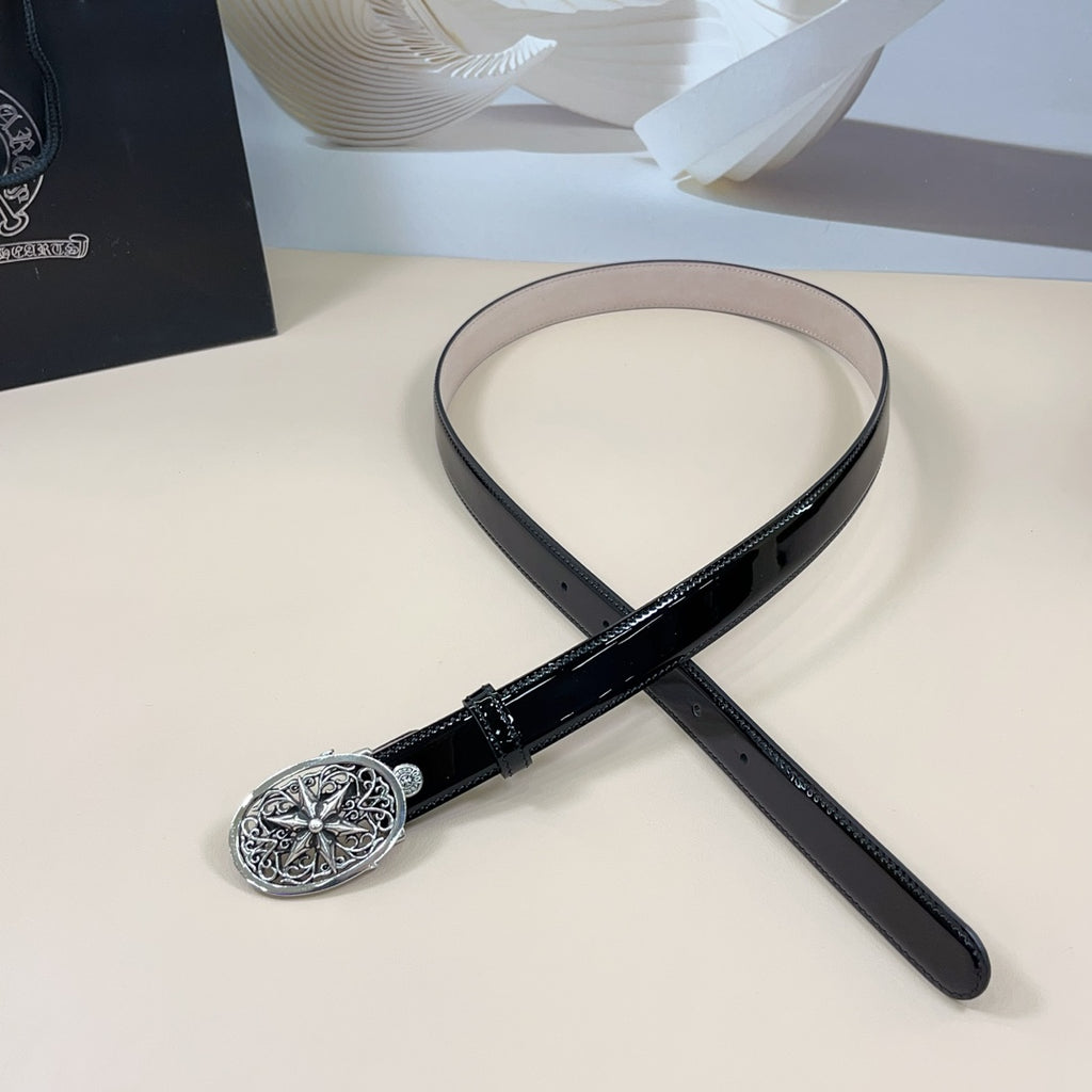 Chrome belt with dark strap and ornate silver oval buckle, shown laid in a loop