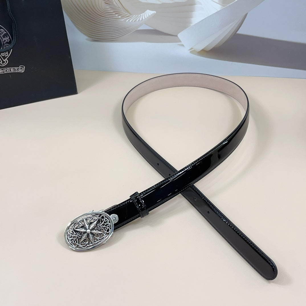 Chrome belt with dark strap and ornate silver oval buckle, shown laid in a loop
