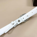 White leather belt with silver pin buckle and round hardware details