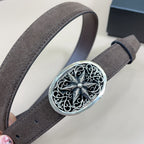 Oval filigree silver buckle on dark brown suede belt with engraved center flower