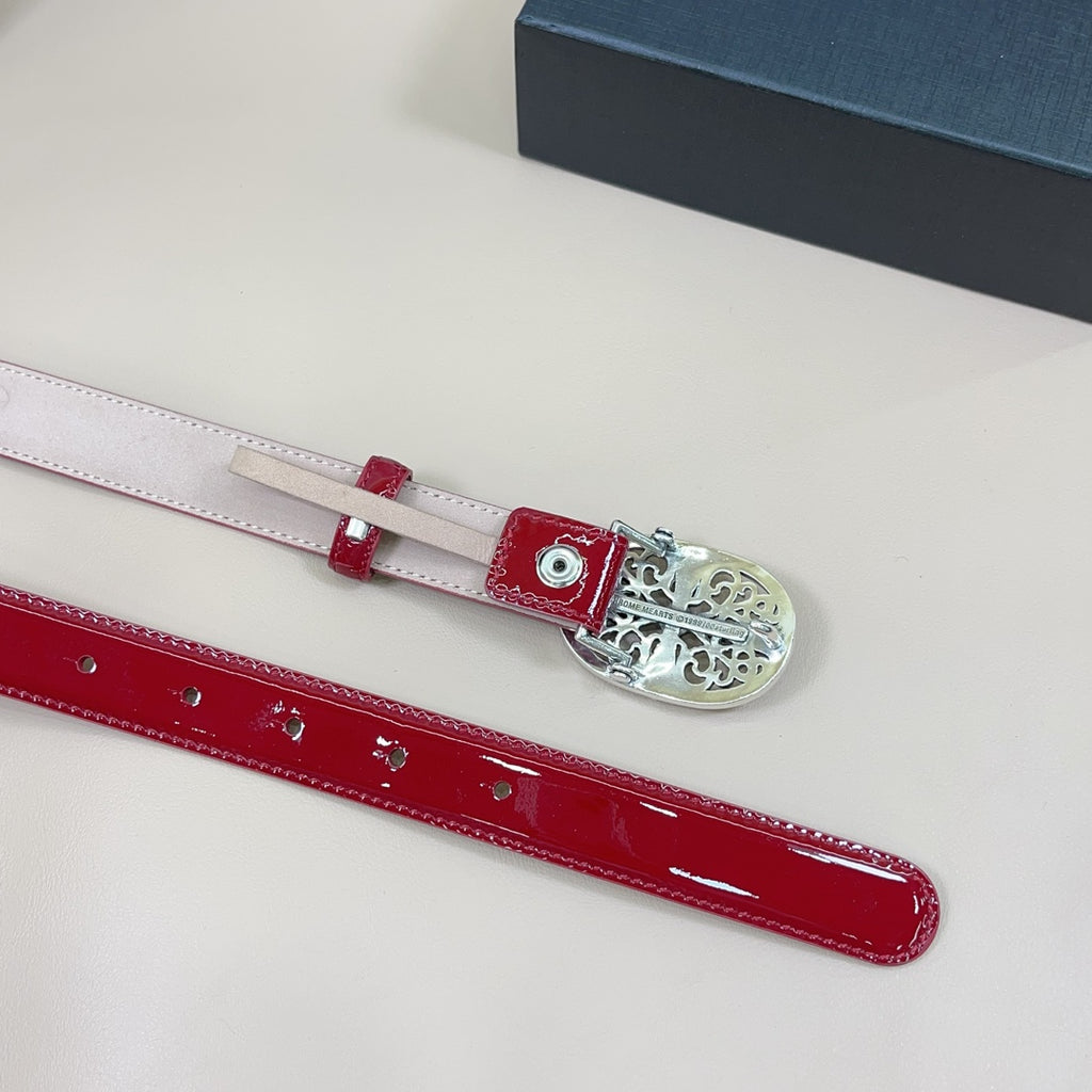 Red patent leather belt laid flat with multiple eyelet holes and silver buckle