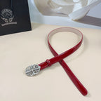 Red leather belt with oval silver filigree buckle and adjustable strap loop