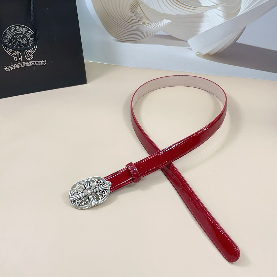 Red leather belt with oval silver filigree buckle and adjustable strap loop