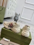 Light beige lace-up sneakers, side and heel view with Gucci logo