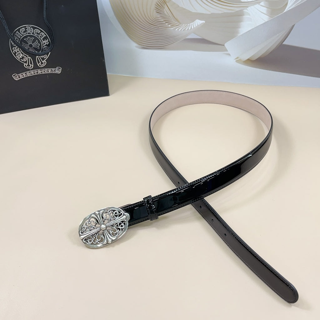 Black patent leather belt with oval silver filigree buckle and looped strap end