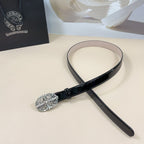 Black patent leather belt with oval silver filigree buckle and looped strap end