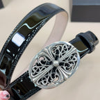 Black patent leather belt with detailed oval silver filigree buckle and gemstone