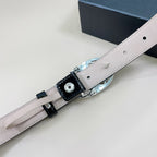Black patent leather belt with light underside and silver-toned buckle hardware