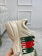 Gucci unisex sneaker sole and side close-up in cream with multicolor stripe graphic