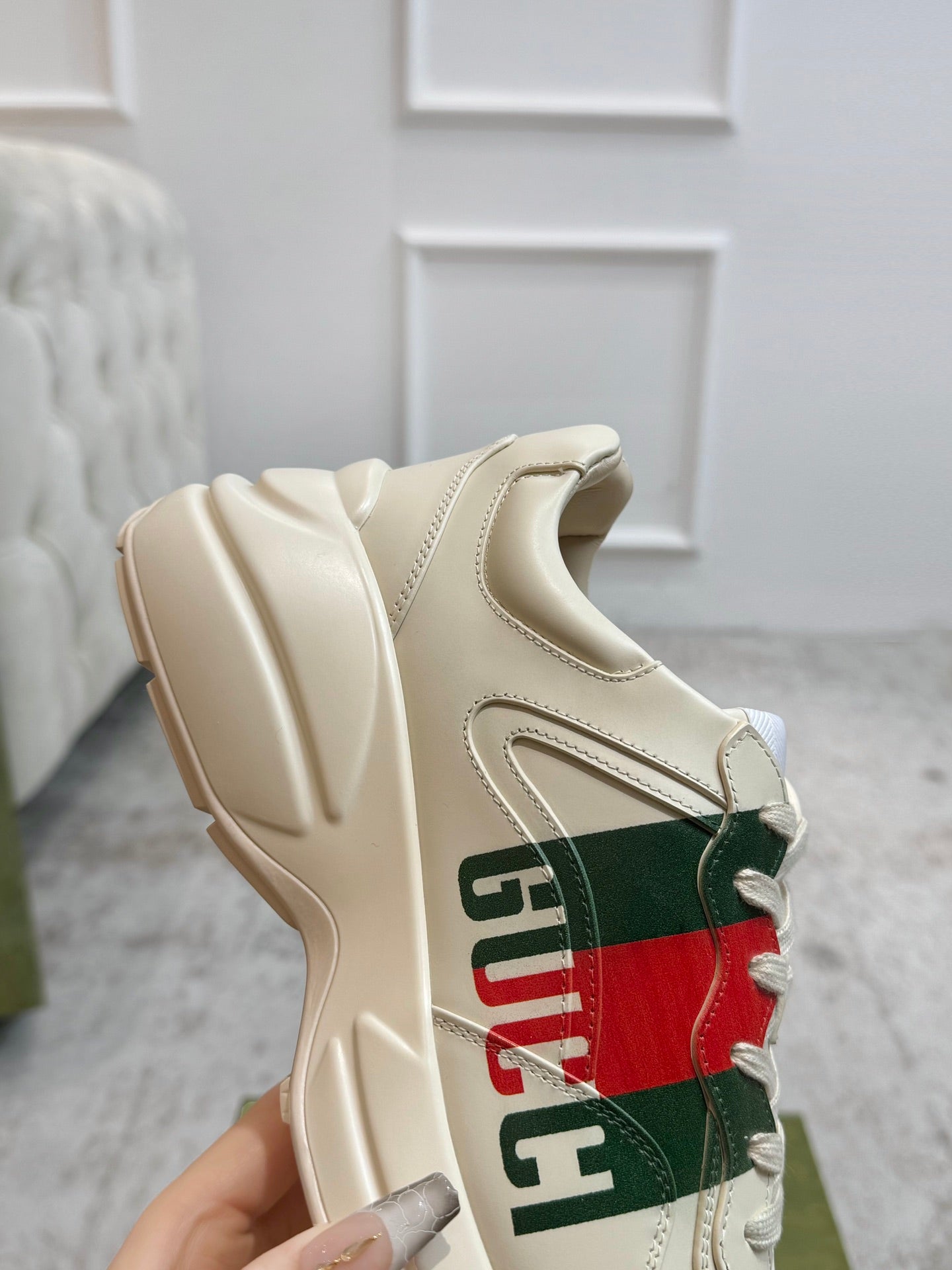 Gucci unisex sneaker sole and side close-up in cream with multicolor stripe graphic