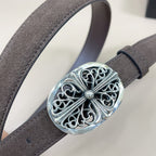 Close-up of dark brown belt with large silver oval filigree buckle and rhinestone center.